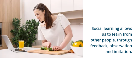 A woman cooking while referring to her laptop. Text: Social learning allows us to learn from other people, through feedback, observation and imitation.