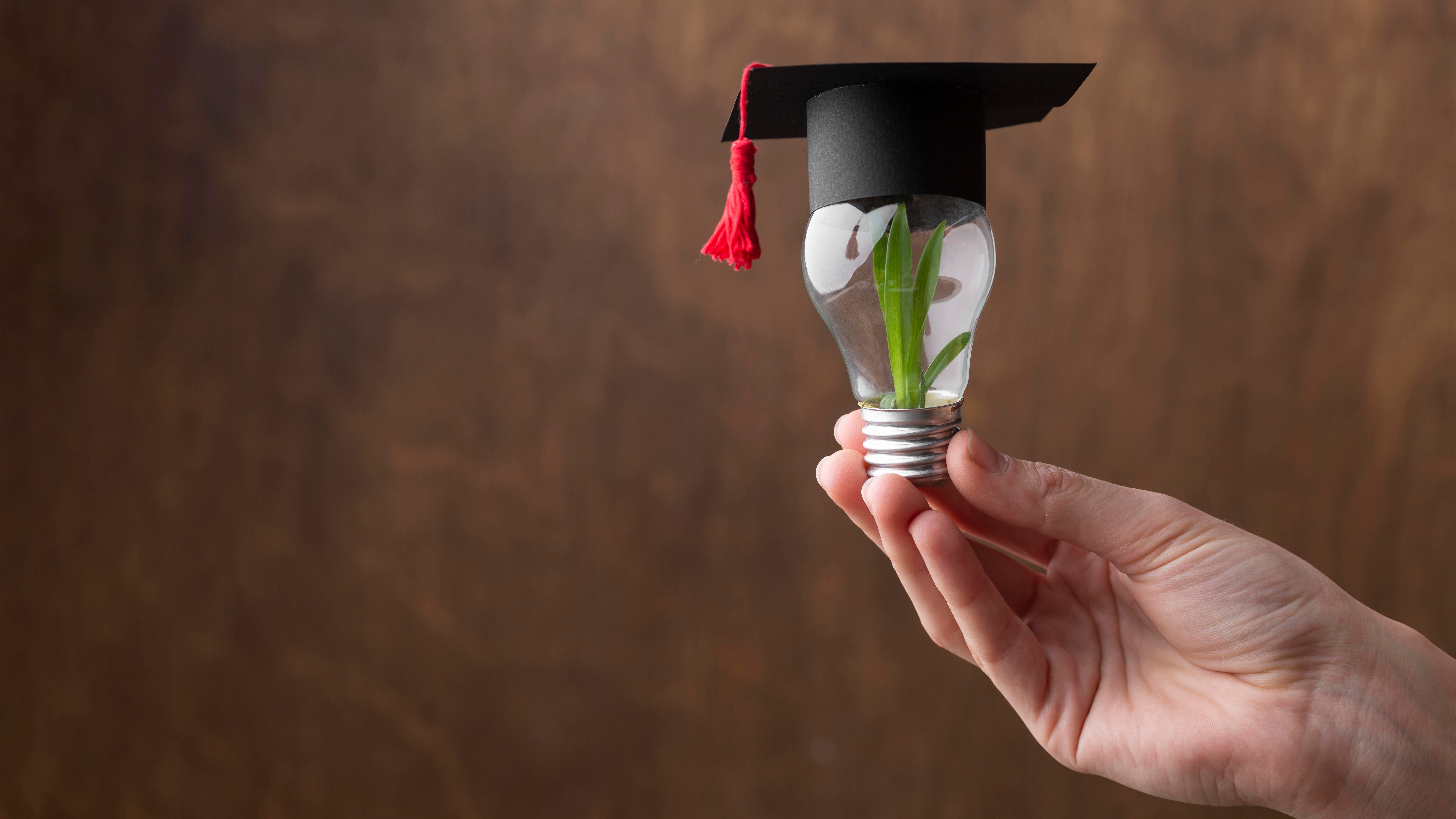 close-up-hand-holding-light-bulb-with-plant